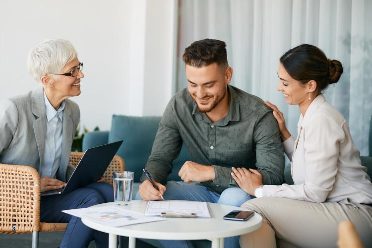 Junges Paar lässt sich von Expertin zuhause beraten